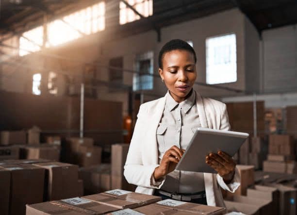 Supplier coordinator checking warehouse stock and delivery details